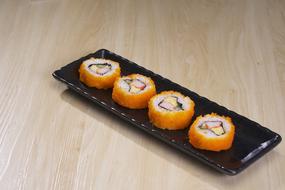 Delicious rolls with caviar on the plate