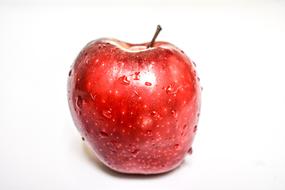 wet red apple on a white background