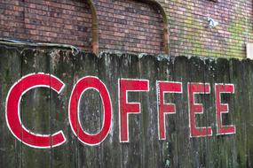 coffee lettering on a wooden fence