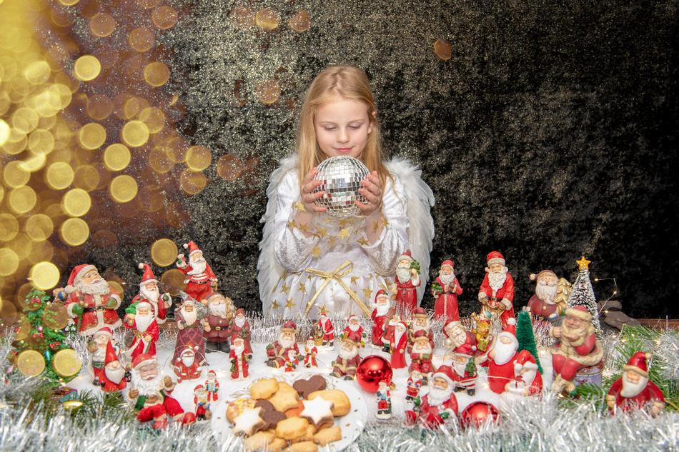 child girl with mirror ball at Christmas baubles
