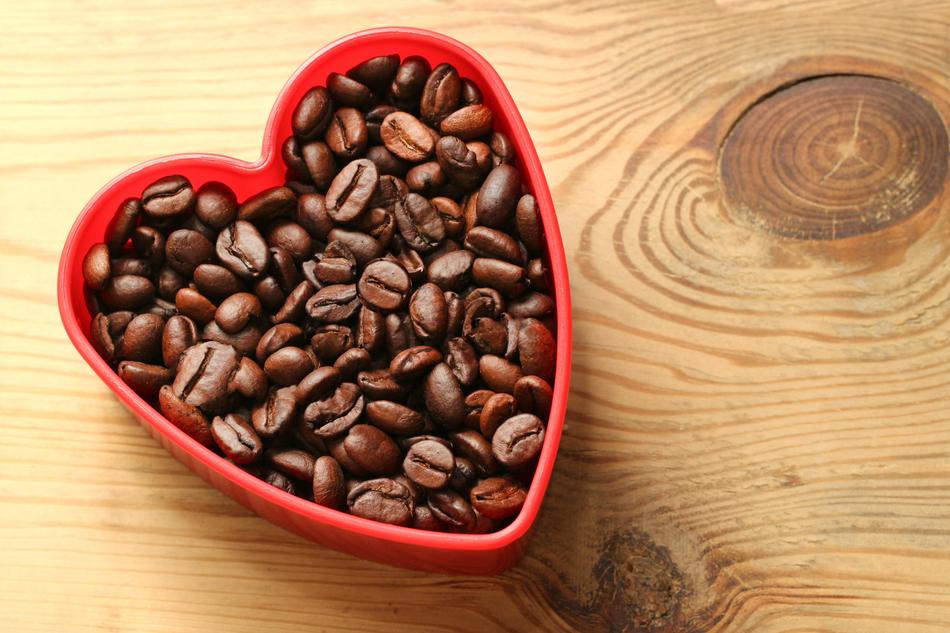 Roasted coffee beans in a red heart box