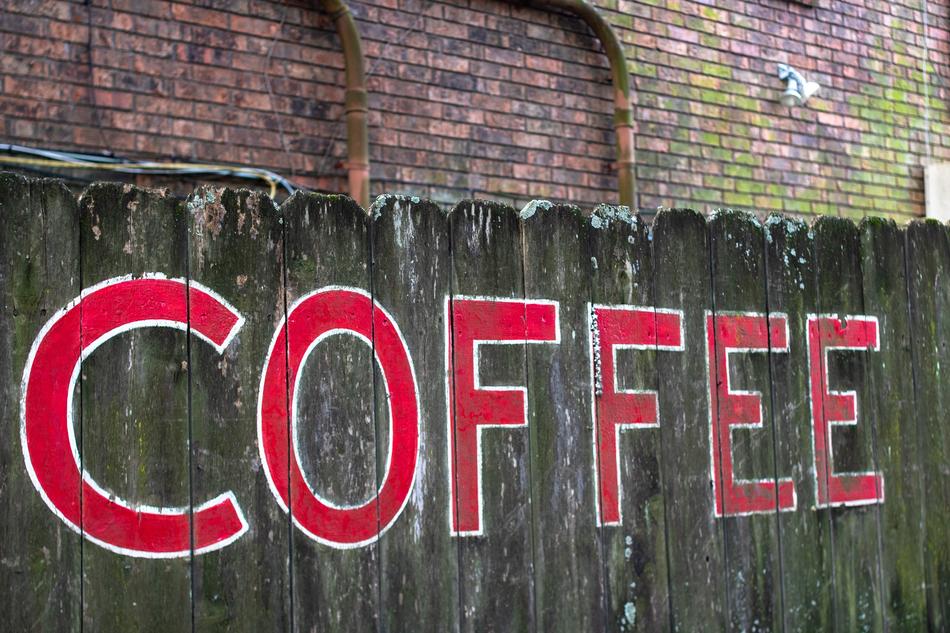 coffee lettering on a wooden fence