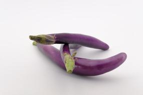 ripe eggplants on a white background