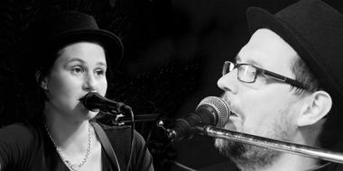 woman and man singing at stage Microphones, black and white