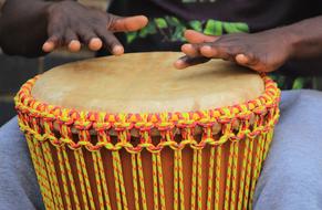 Jemba Drumming, hands of dark skin boy at drum