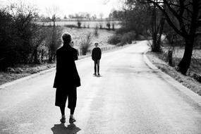 black and white, photographer takes a picture of a boy outdoors