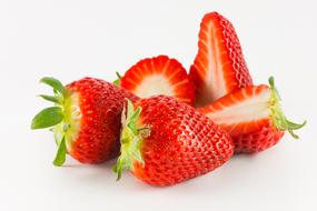 sliced delicious strawberries on a white background