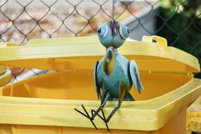 iron bird on a yellow bucket