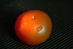 tasty tomato on a black background