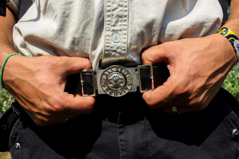 Human holding Belts on Pants