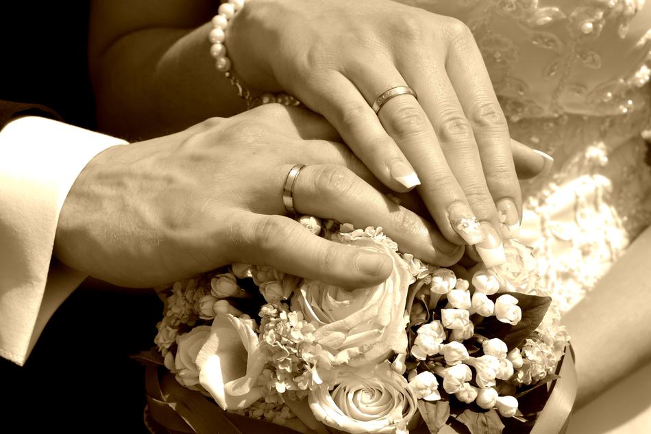 the hands of the man with the bouquet