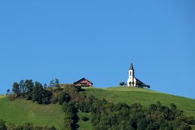 white church in a meadow in a field