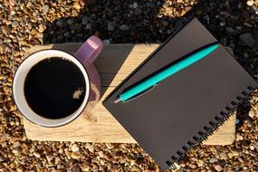 hot coffee by the notepad
