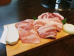 meat slicing pork on a board