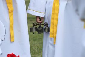 green bells in the hands of a man