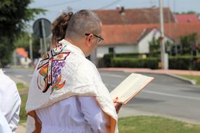 a monk in a suit and a bible