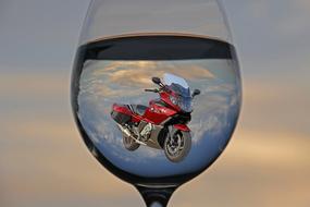 sports red motorcycle in a glass of water