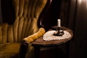 Candlelight on Chair in Dark Room