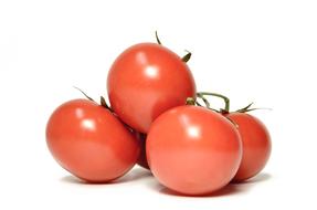 Ripe juicy tomatoes on a white background