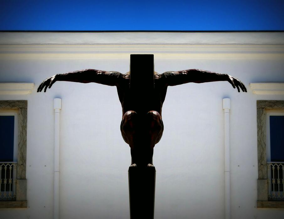 Silhouette of the figure of the man, near the building with windows