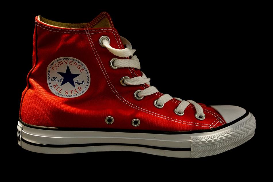 red sneaker on a black background