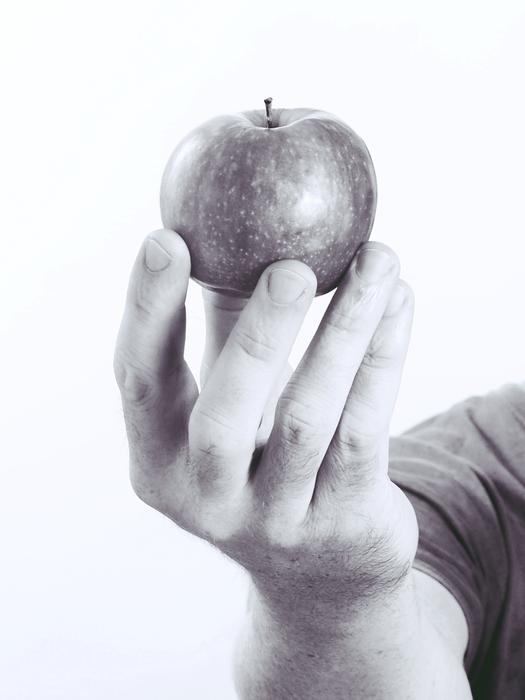 small apple in his hand