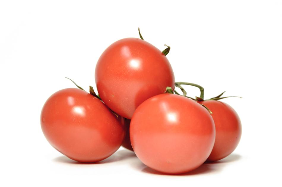 Ripe juicy tomatoes on a white background