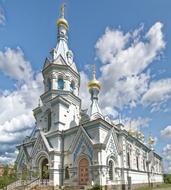 white church with clouds on a blue background