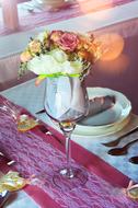 glass on the table with flowers