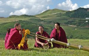 people in red suits in the meadow