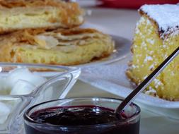 Breakfast with baked goods and strawberry jam