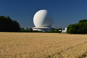 Radar dome, among the colorful and beautiful plants, at blue sky on backgroind