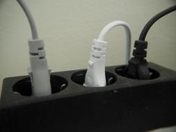 Grey, white and black plugs in the black sockets