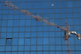 construction crane reflecting in windows