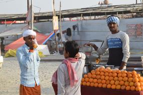 man sells orange juice to children