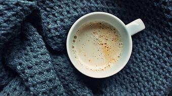 delicious milk coffee on a soft blanket