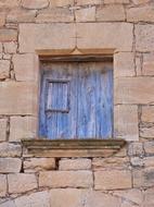 wooden shutters and medieval stone facade