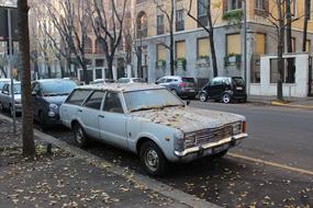 old dirty car on the street in Milan