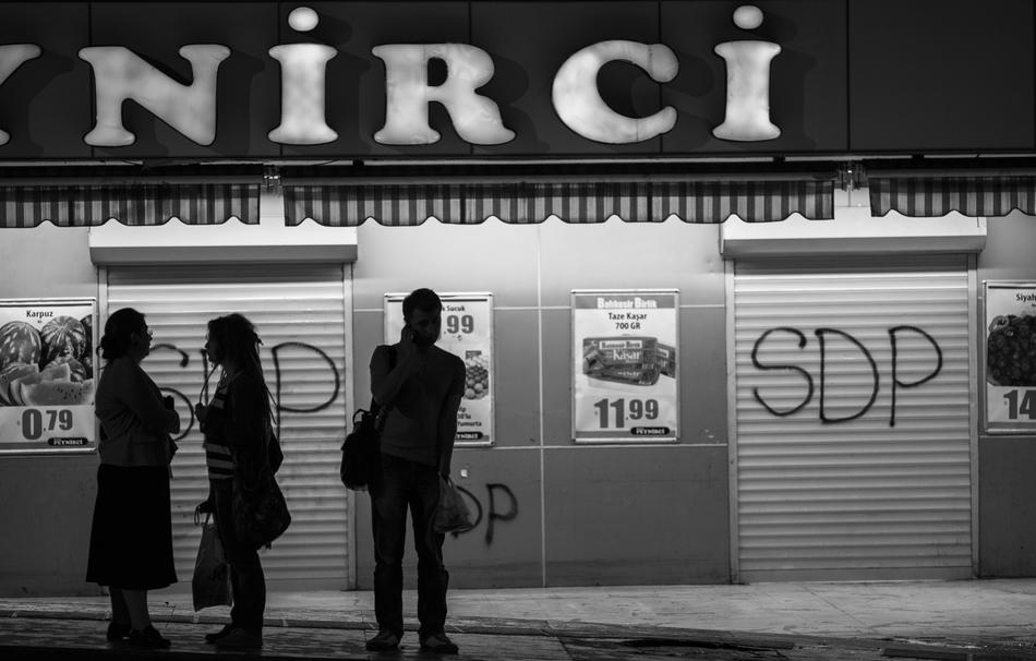 black and white, people on the sidewalk at night