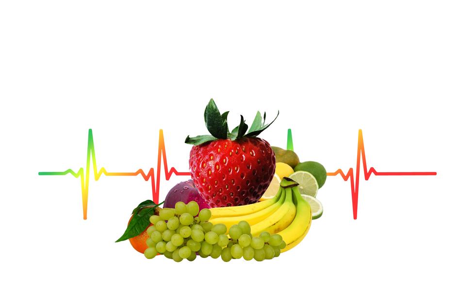 fruits and berries on cardiogram background