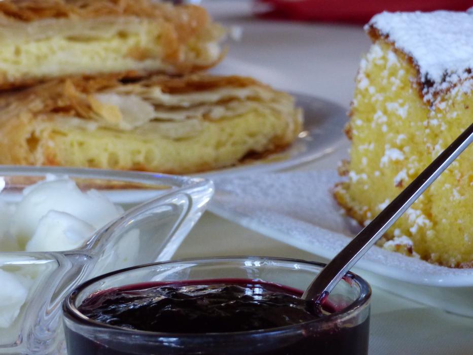 Breakfast with baked goods and strawberry jam