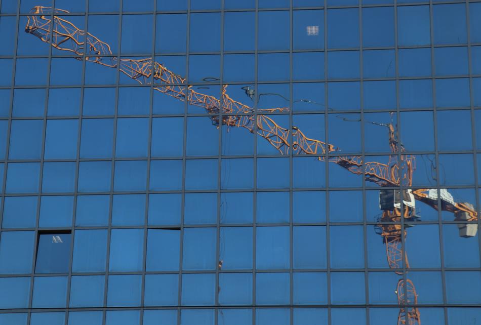 construction crane reflecting in windows