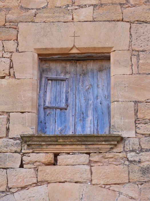 wooden shutters and medieval stone facade
