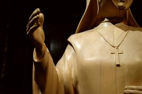 nun with a cross sculpture