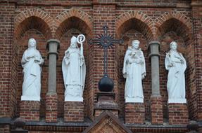 white sculptures of saints in the house