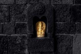 black stone with a golden buddha