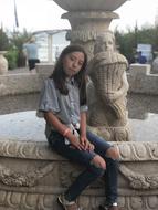 Girl and water fountain in park