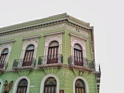 green facade of a historic building in mexico city