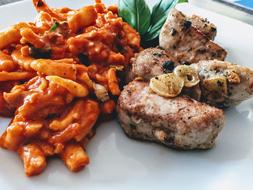 fried meat with noodles in sauce