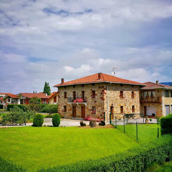 stone house near the green grass